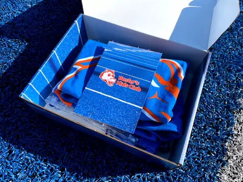 An opened Buster's Kids Club Box sits on The Blue turf
