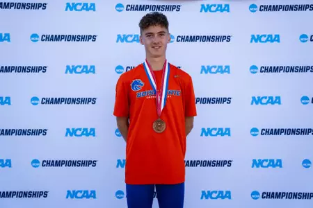 Joe Hudson smiling with his medal