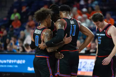 Photo of Roddie Anderson III and Chibuzo Agbo in team huddle 2023.