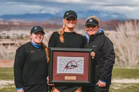 Franca Polla holding her plaque with coaches Kailin Down and Lexi Perry after finishing third at Lady Thunderbird Invitational