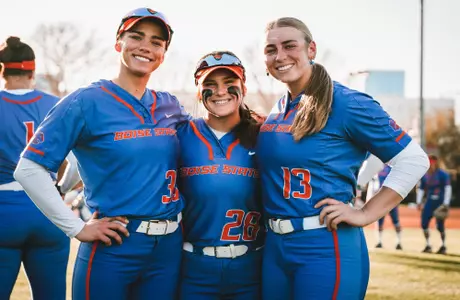 Kelsey Hall, Jordyn Hutchins, and Mykenzie Hanna smile for a photo after the 4-3 win against UNLV to open conference play, March 17, 2023.