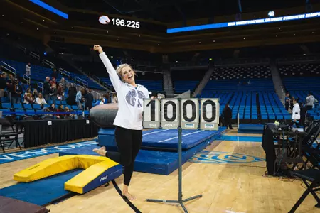 Courtney Blackson poses with a 10 score sign at the NCAA Regional Championships