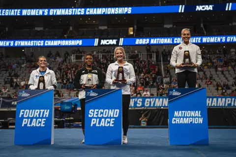Courtney Blackson takes podium pictures at the NCAA Championships after being named the national runner-up on vault