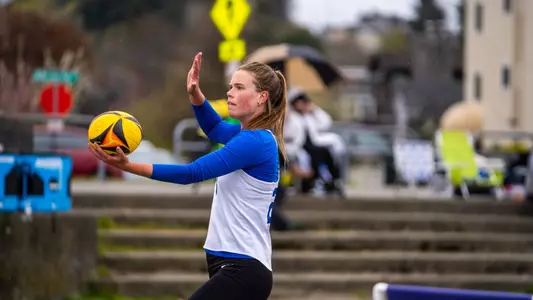 Photo, Ava Anderson serving during a match at the Husky Invitational, April 16, 2023