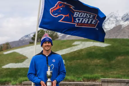 Max Charles holding the trophy after winning the PING Cougar Classic.