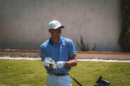 Max Charles smiles while cleaning his club.