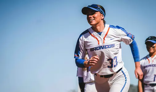 Kelsey Hall smiling and running during warm ups against Colorado State March 25, 2023 at Dona Larsen Park.