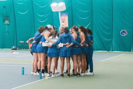A photo of the Boise State women's tennis team huddled after a match.