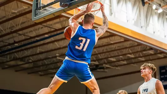 Cam Martin dunks the ball in a game against Trinity Western.