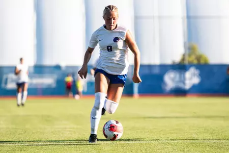 Carly Cross dribbling up the field against College of Idaho.