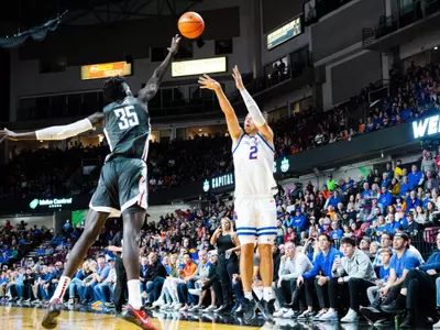 Tyson Degenhart shoots a 3-pointer over a Washington State defender.