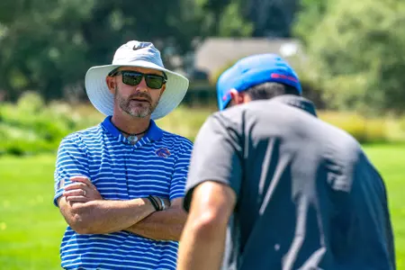 David Trainor works with a golfer during practice.