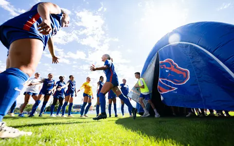 Ali Chatterton running to field for starting lineup announcement against Oregon State.