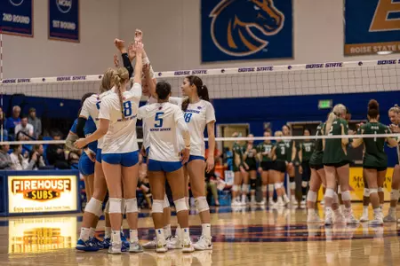 Boise State Volleyball huddles together during a match against Colorado State at Bronco Gym.