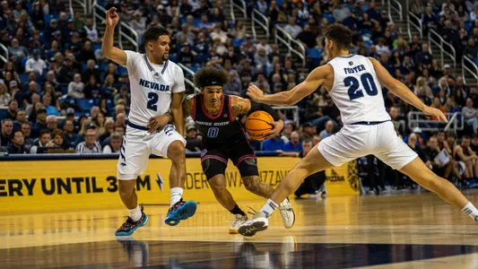 Roddie Anderson III dribbles past Nevada defenders.