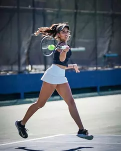 Maya Dutta hitting the tennis ball