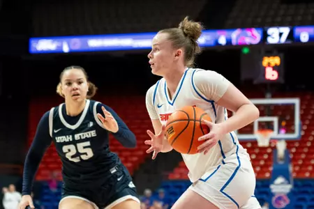 Dani Bayes drives to the basket against Utah STate