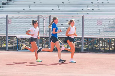 Bianca Boehnke, Amit Koma, and Hanna Ackermann running at cross country practice
