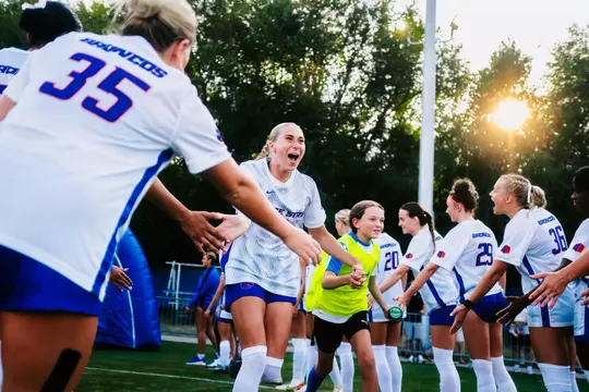 Avery McBride running down the line giving high-fives.