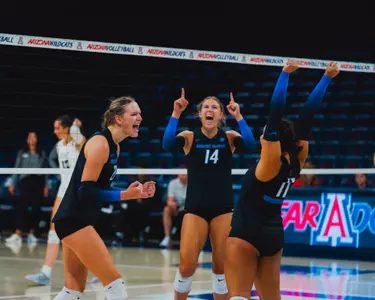 Annie Kaminski, Paige Bartsch and Bre Mitchell celebrate a point during the match against VCU.