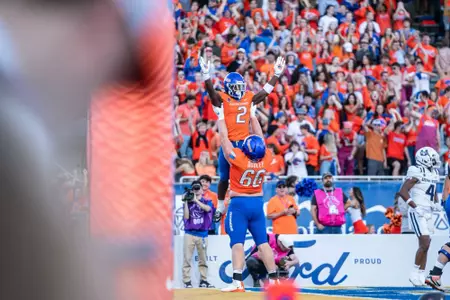 Ben Dooley hoists Ashton Jeanty up following a touchdown as No. 21 Boise State defeated Utah State 62-30 in the conference opener at Albertsons Stadium on Oct. 5, 2024. (Photo by Kenna Harbison).