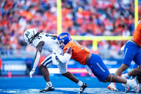 Ahmed Hassanein takes down a defender as No. 21 Boise State defeated Utah State 62-30 in the conference opener at Albertsons Stadium on Oct. 5, 2024. (Photo by Kenna Harbison).