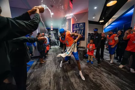 A'Marion McCoy celebrates postgame in the locker room as No. 21 Boise State defeated Utah State 62-30 in the conference opener at Albertsons Stadium on Oct. 5, 2024. (Photo by Kenna Harbison).