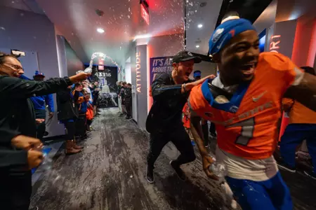 Head coach Spencer Danielson and A'Marion McCoy celebrate in the locker room postgame as No. 21 Boise State defeated Utah State 62-30 in the conference opener at Albertsons Stadium on Oct. 5, 2024. (Photo by Kenna Harbison).