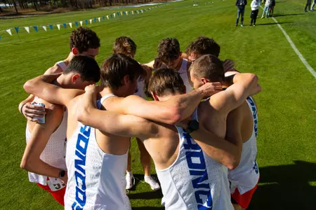 Men's Cross Country Team huddling