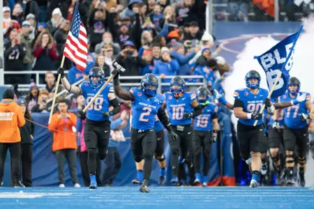 Ashton Jeanty leads the Boise State football team on the field before playing San Diego State