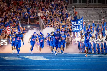 Boise State football running out of tunnel. Michael Callahan carrying Dan Paul Hammer