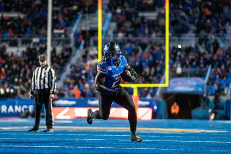 Ashton Jeanty carrying the ball for a gain on The Blue