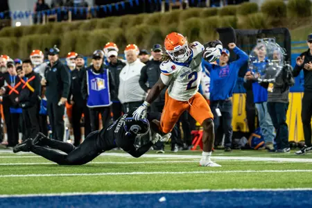 Ashton Jeanty stiff-arming a San Jose State defensive back on his way to the end zone