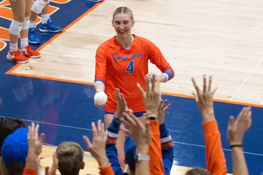 Reagan Casey giving a child a mini ball during the pregame introductions for the New Mexico match on October 5, 2024.
