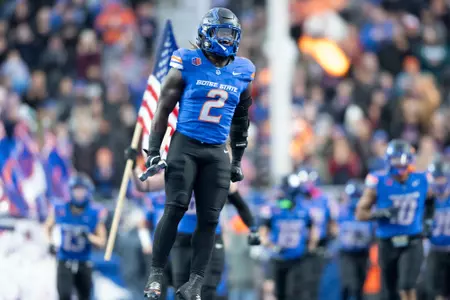 Ashton Jeanty leaping while carrying Dan Paul Hammer