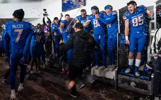 Players celebrating in the locker room after defeating Oregon State in 2024.