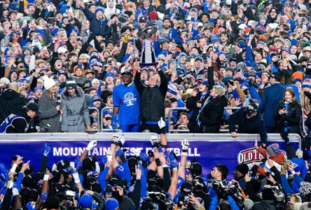Coach Spencer Danielson raising 2024 MW Championship trophy in front of Bronco Nation following the game on December 6, 2024.