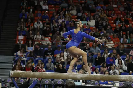 Emily Lopez competing on beam at home.