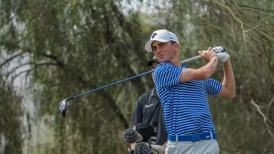 Cole Rueck tracks his tee shot at the Loyola Intercollegiate