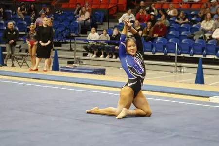 Emma Loyim competing on floor.