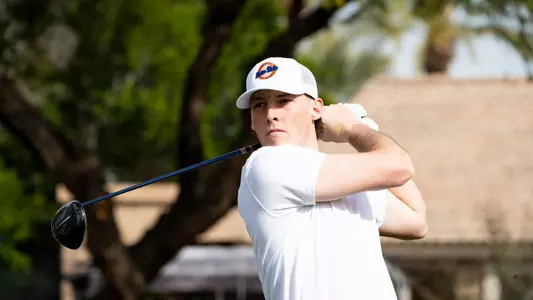 Will O'Connor tracks his tee shot on the course.