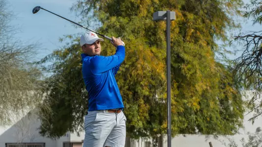 Alex Talbot tracks his tee shot at the Loyola Intercollegiate
