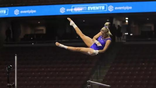 Courtney Blackson warming up on bars before competition.