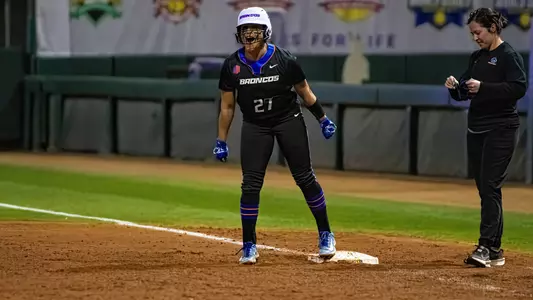 Alycia Flores celebrates a hit at LSU standing on first base.