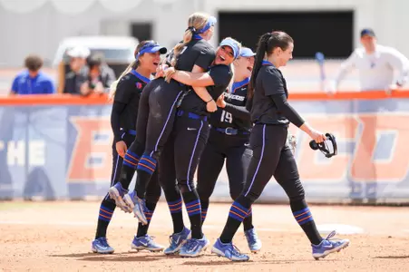 Team celebrates Sophia Knight's catch that took away a three-run home run.