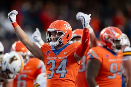 Alexander Teubner raising arms in celebration during 2023 game vs. Wyoming