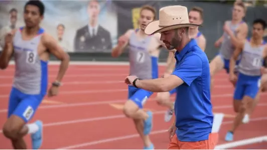Pat McCurry checking his watch while coaching
