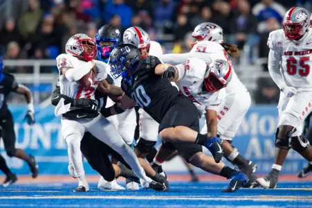 Boise State defensive tackle Braxton Fely makes a tackle against New Mexico in 2023.