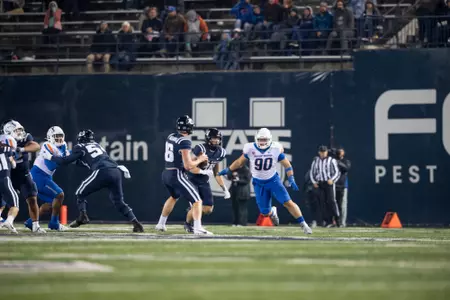 Boise State defensive tackle Braxton Fely makes a tackle and celebrates at Utah State in 2023.