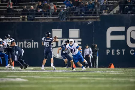 Boise State defensive tackle Braxton Fely makes a tackle and celebrates at Utah State in 2023.